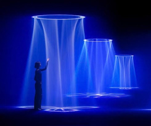 A figure reaching toward cones of blue light